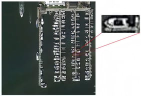 The context of the small object is necessary to recognize the boat in the image.
