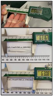 Photographs of CaF2 single crystals doped with: (a) 1 mol% TbF3; (b) 5 mol% TbF3; (c) 10 mol% TbF3. The measured crystal lengths are indicated.
