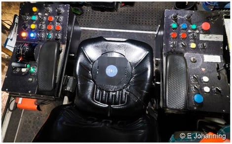 Operator seat system with attached side consoles and monitors showing seat pad sensor location (view from top) (© E. Johanning).