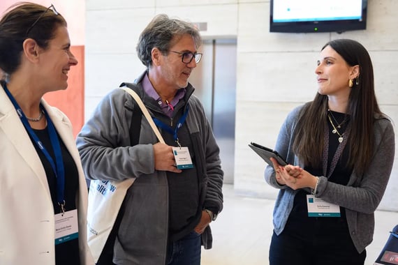 Three colleagues having a discussion in an office setting
