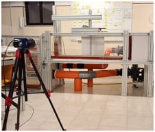 General overview of the water tunnel facility, showing the test section, the aluminium plate, and the optical acquisition system.