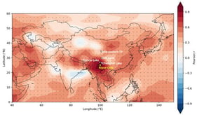 Spatial correlation between annual mean temperature at the Riyue Cave site and surface air temperature over Asia. Pearson correlation coefficients were calculated between the annual mean temperature series at the grid point nearest to Riyue Cave (25° N, 100° E) and annual mean temperature at each grid cell across the Asian domain (40–150° E, 0–60° N) using NOAA NCEP/NCAR Reanalysis 1 monthly surface air temperature data (air.mon.mean) for the 1950–2024 period. Warm colors indicate positive correlations, whereas blue colors indicate negative correlations. Stippled areas denote correlations significant at p < 0.05. White circles mark the locations of the paleotemperature records used in this study.