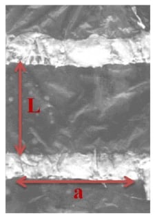 Photograph of PPy film on PE, with silver ink bands as electrical contacts.