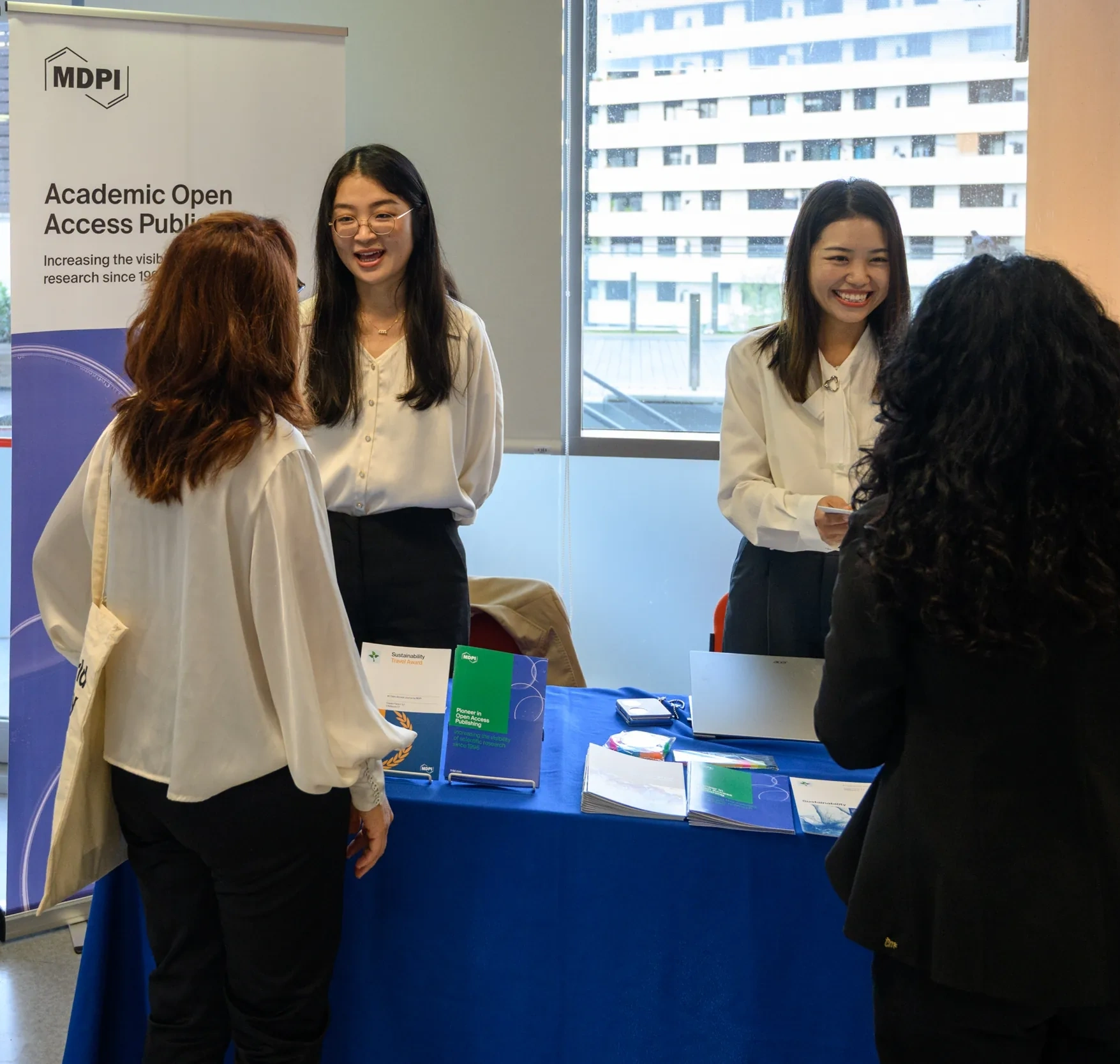 Two people smiling at a conference booth