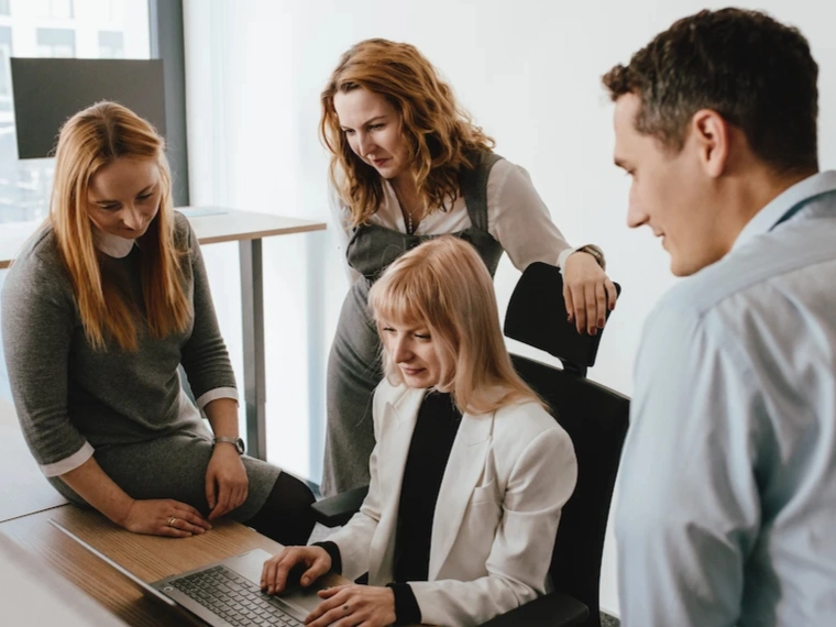 A group of people working on a computer